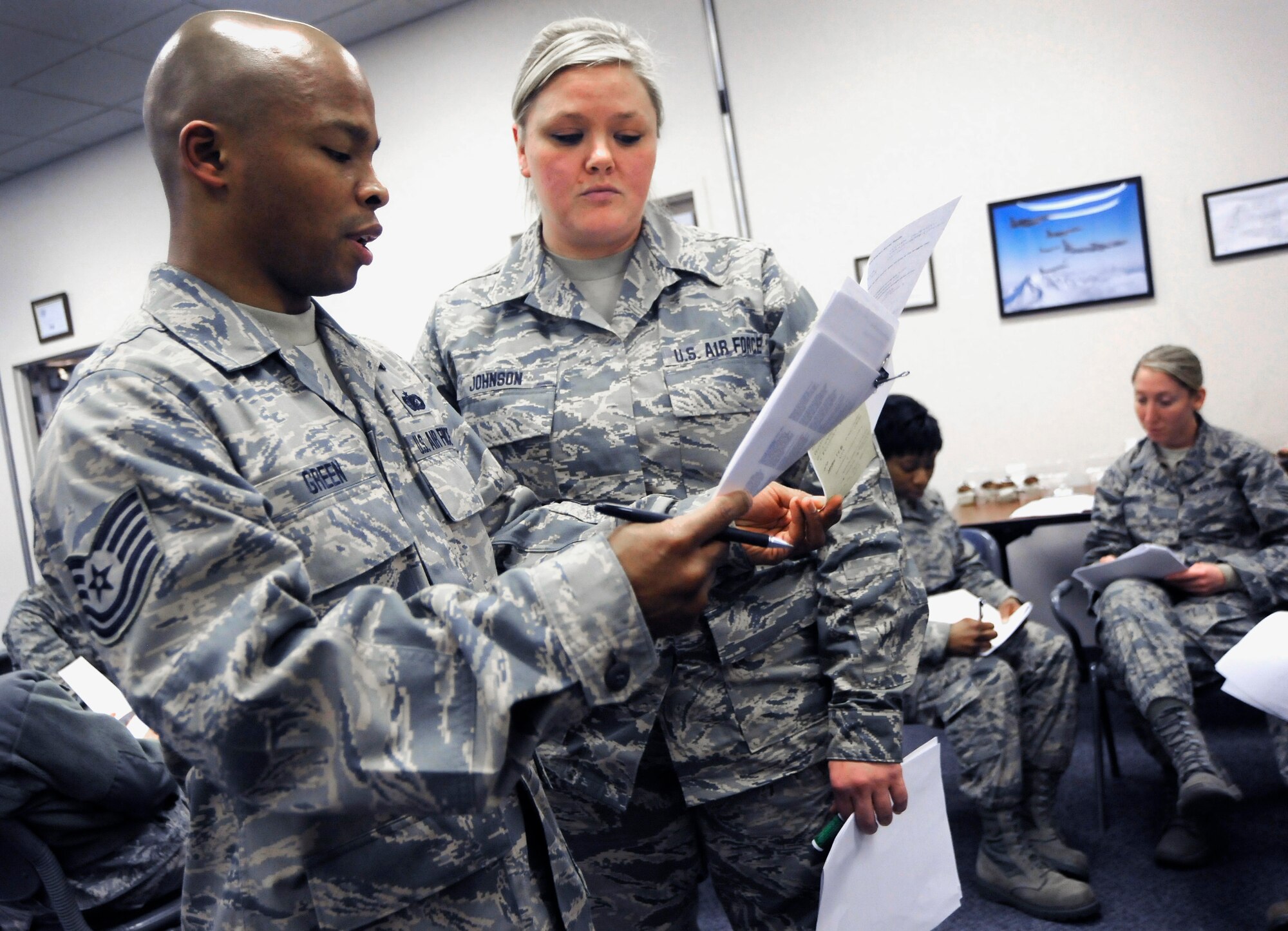 Oregon Air National Guard Tech. Sgt. Carl Green and Airman 1st Class Michelle Johnson, 142nd Fighter Wing Diversity and Inclusion Counsel’s co-chairs review notes during a group activity as part of the monthly Unit Training Assembly weekend of events, Jan. 11, 2015, Portland Air National Guard Base, Ore. The Diversity and Inclusion Counsel helps foster communication by recognizing that a diverse set of experiences, perspectives, and backgrounds are crucial to mission success. (U.S. Air National Guard photo by Tech. Sgt. John Hughel, 142nd Fighter Wing Public Affairs/Released)