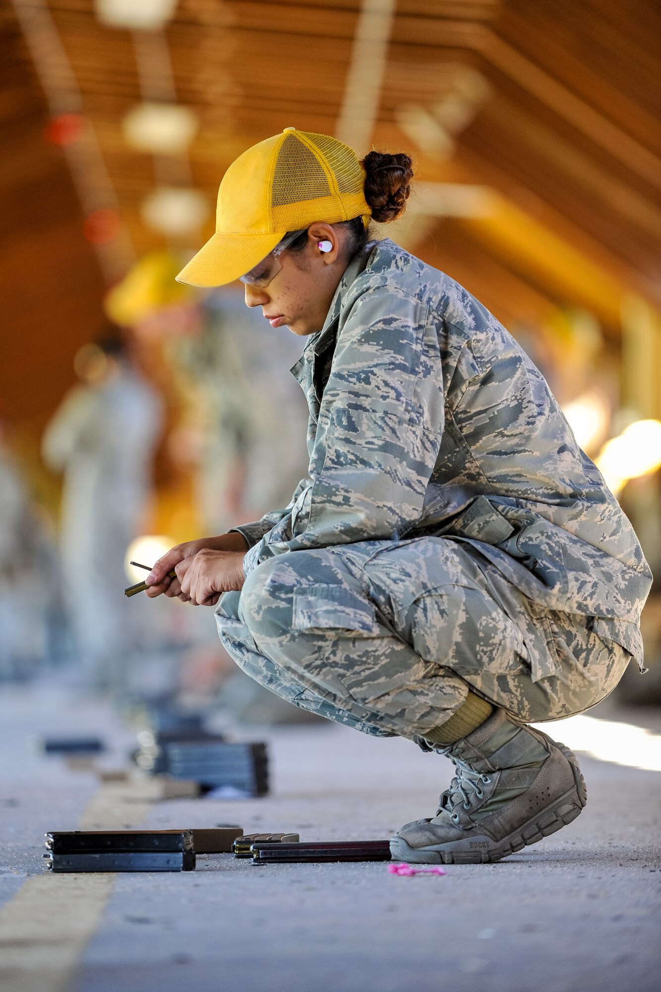 Melissa De Sousa, assigned to the Flying Tigers Basic Cadet Training Squadron, takes a break from firing the M4 Carbine Rifle at the U.S. Air Force Academy's Combat Arms firing range June 22, 2015. All BCT squadrons are scheduled to take a weapons familiarization course at the range July 21-28. (U.S. Air Force photo/Liz Copan)