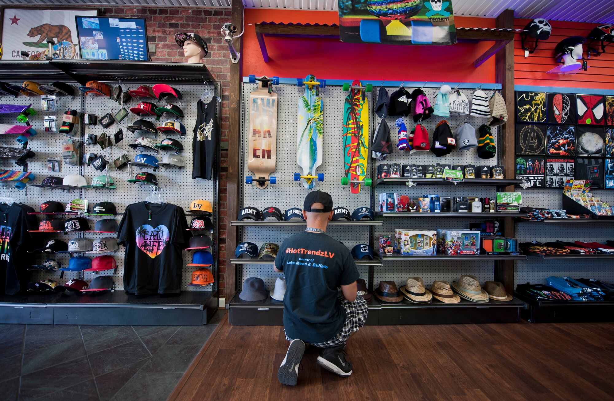 Retired Tech. Sgt. Alfredo Sibucao Jr. organizes a hat display inside his retail store in Las Vegas, June 22, 2015. Sibucao, who attended middle and high school in Las Vegas, spent a combined 13 years between Nellis and Creech Air Force Bases before retiring and opening his business in Las Vegas. (U.S. Air Force photo by Staff Sgt. Siuta B. Ika)