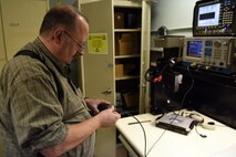 Bruce Clark, 341st Communications Squadron base radio electronics technician, performs a systems check on a land mobile radio, July 21, 2015, at Malmstrom Air Force Base, Mont.  The shop maintains more than 1,100 portable radios, 600 mobile radios and 70 base stations located throughout the base and the missile complex. (U.S. Air Force photo/Chris Willis)