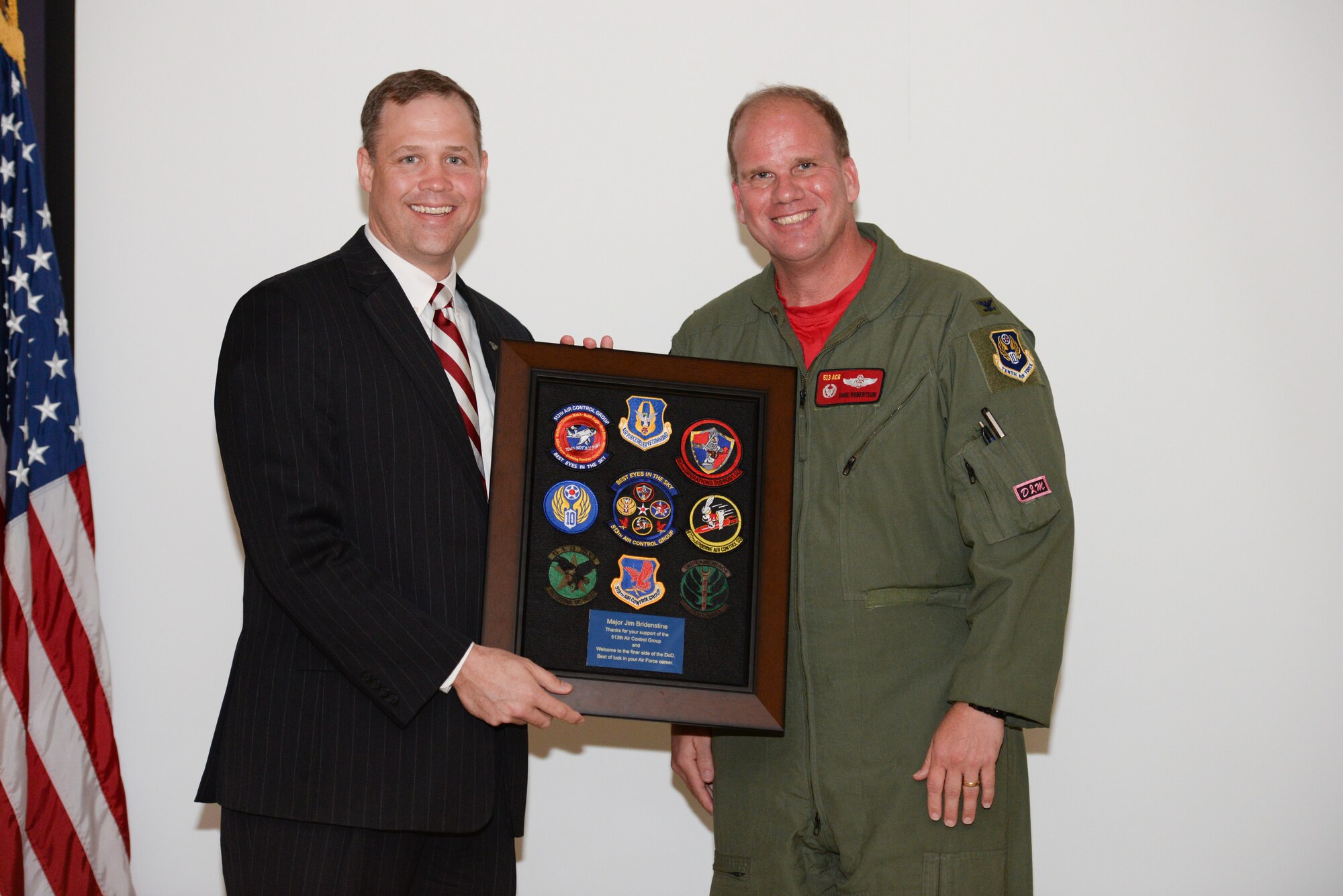 Col. David Robertson, the 513th Air Control Group commander, presents U.S. Rep. Jim Bridenstine with unit patches on July 11 from the 513th during a pre-deployment briefing for reservists at Tinker Air Force Base, Okla. Bridenstine, a pilot with the Oklahoma Air National Guard, thanked the Airmen and their spouses for their sacrifice and spoke of the vital part the Air Force Reserve plays in today’s military. (U.S. Air Force photo by Staff Sgt. Caleb Wanzer)