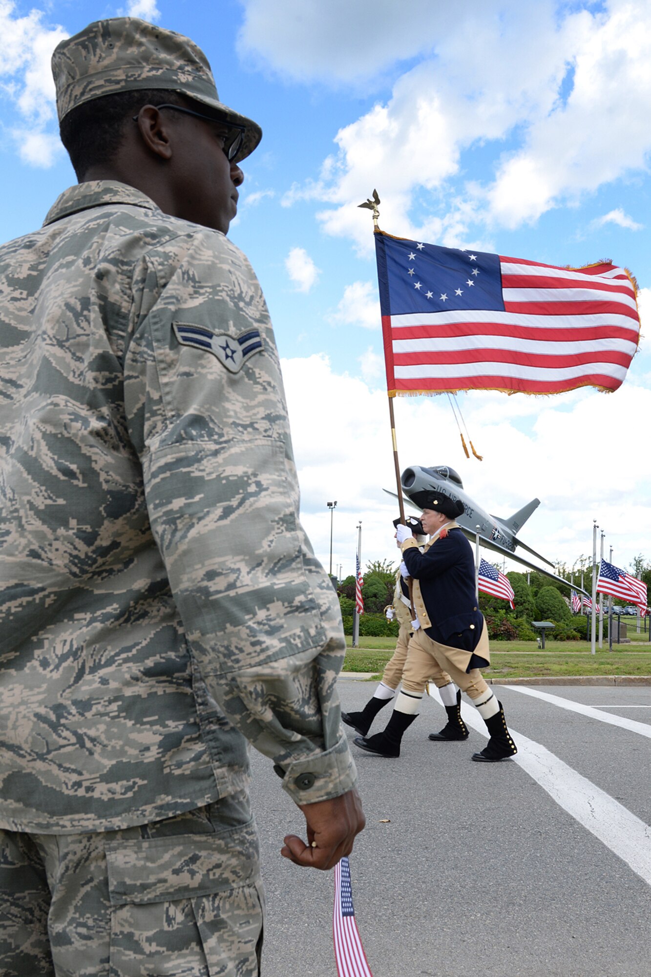 Airmen line the streets on base to recognize service members who have returned home from deployment in the past year during a Heroes Homecoming celebration July 23. Among those honoring Airmen at the celebration were community organizations and local professional sports franchises. (U.S Air Force photo by Linda LaBonte Britt)