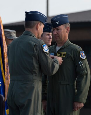 U.S. Air Force Col. Chad Franks, outgoing 23d Wing commander, receives a Legion of Merit Award from Maj. Gen. H.D. Polumbo, Ninth Air Force commander, during the 23d Wing Change of Command ceremony July 23, 2015, at Moody Air Force Base, Ga. The wing achieved more than 600 combat saves and zero combat losses while under Franks’ command.  (U.S. Air Force photo by Staff Sgt. Eric Summers/Released)