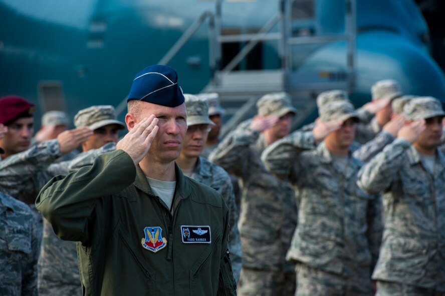 U.S. Air Force Lt. Col. Christopher Barber, 347th Rescue Group deputy commander, salutes the flag during the playing of the National Anthem during the 23d Wing Change of Command ceremony July 23, 2015, at Moody Air Force Base, Ga. The change of command ceremony is a part of military history signifying the hand-off of responsibility of a unit from one commander to another. (U.S. Air Force photo by Staff Sgt. Eric Summers/Released)