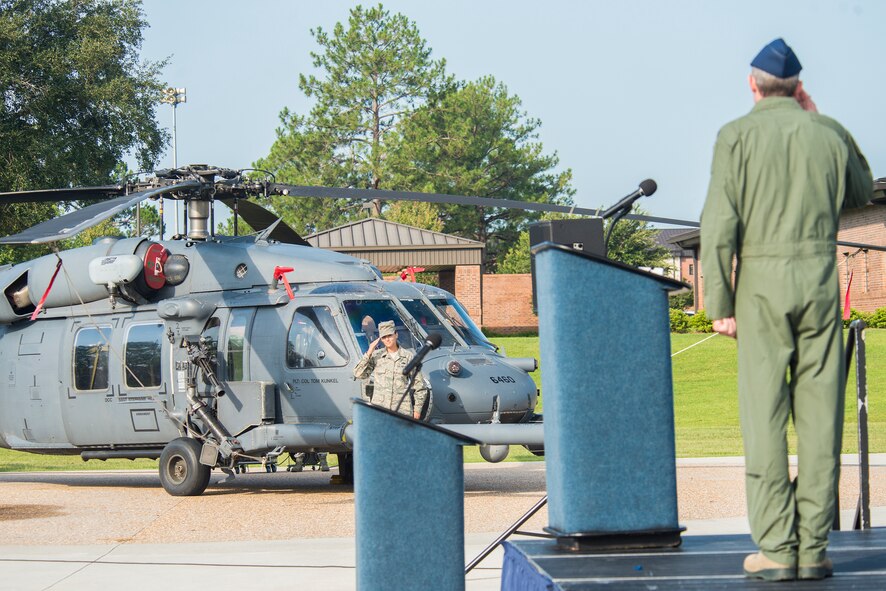 U.S. Air Force Col. Thomas Kunkel, (right), 23d Wing commander, renders a salute to Staff Sgt. Stephanie Hill, during the 23d WG Change of Command ceremony July 23, 2015, at Moody Air Force Base, Ga. Hill revealed Kunkel’s name on his flagship HH-60G Pave Hawk. (U.S. Air Force photo by Airman 1st Class Ceaira Tinsley/Released)