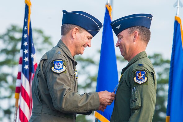 U.S. Air Force Maj. Gen. H.D. Polumbo Jr., (left), Ninth Air Force commander, and Col. Chad Franks, outgoing 23d Wing commander, pins the Legion of Merit Award to Franks during the 23d WG Change of Command ceremony July 23, 2015, at Moody Air Force Base, Ga. Franks awarded the medal for his leadership which led the wing to fly more than 11,000 combat hours and conducted 600 combat saves with zero combat losses. (U.S. Air Force photo by Airman 1st Class Ceaira Tinsley/Released)