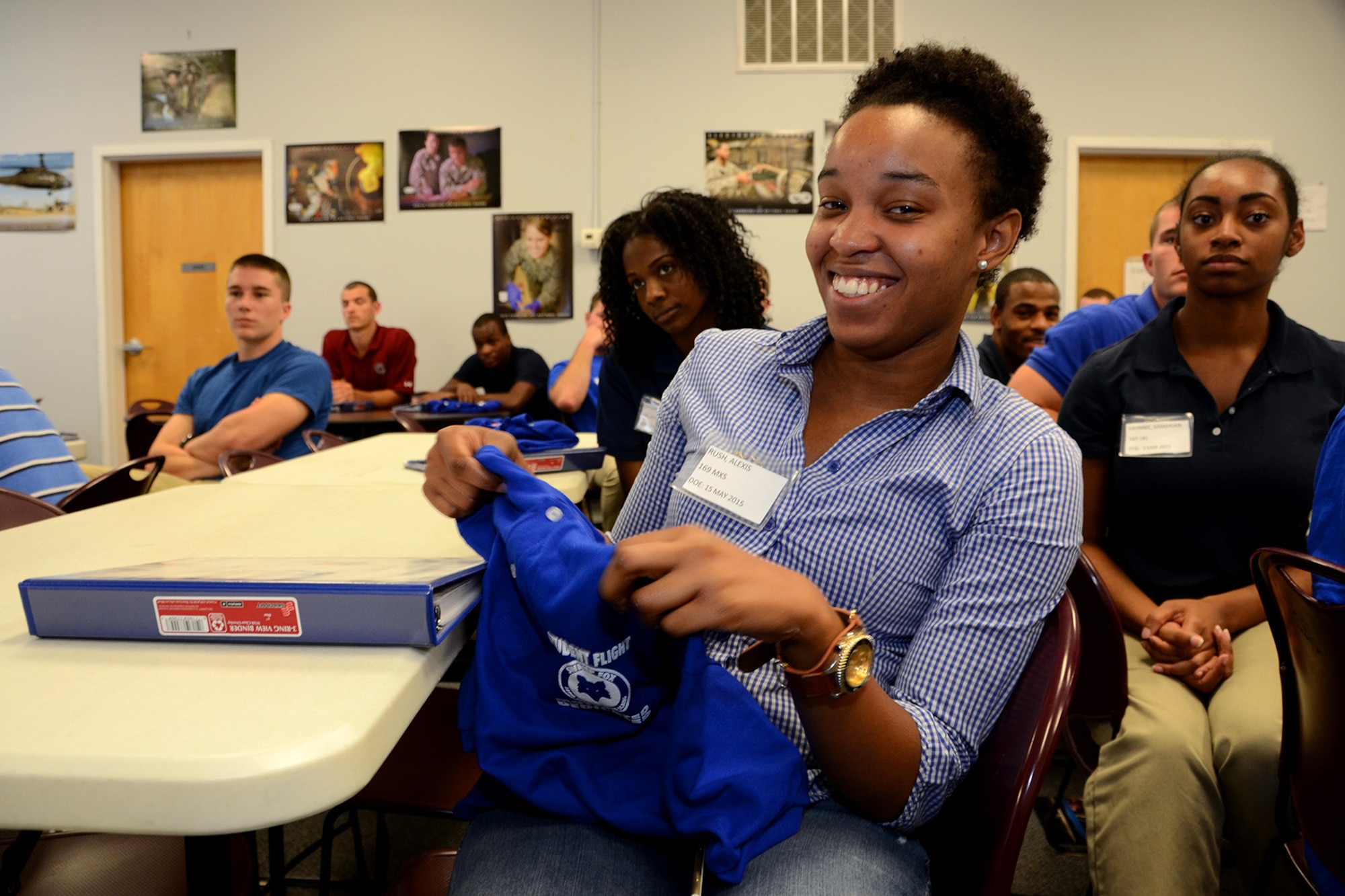 U.S. Air Force Airman Alexis Rush, assigned to the 169th Student Flight, holds up her Student Flight shirt at McEntire Joint National Guard Base, S.C., June 13, 2015. The trainees received shirts and binders that include useful information in a ceremony to help introduce them into the Swamp Fox family. (U.S. National Guard photo by Amn Megan Floyd/Released)