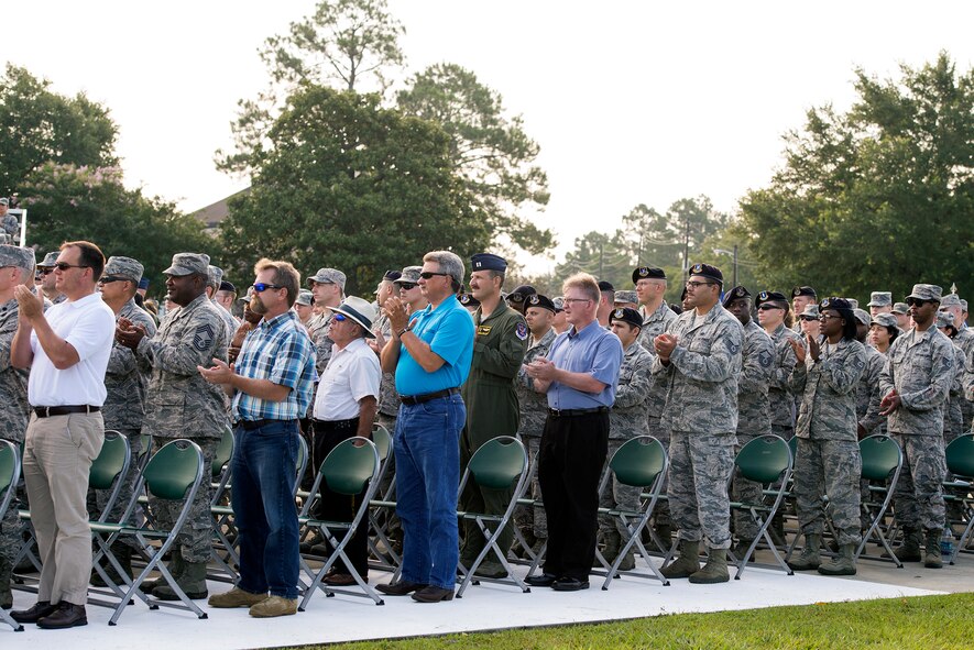 Members of the 23d Wing, family and community leaders clap after U.S. Air Force Col. Chad Franks, outgoing 23d WG commander, receives a Legion of Merit Award during the 23d WG Change of Command ceremony July 23, 2015, at Moody Air Force Base, Ga. Franks lead the 23d Wing for two years and will assume command as the senior executive officer to the Air Force chief of staff. (U.S. Air Force photo by Airman Greg Nash/Released)