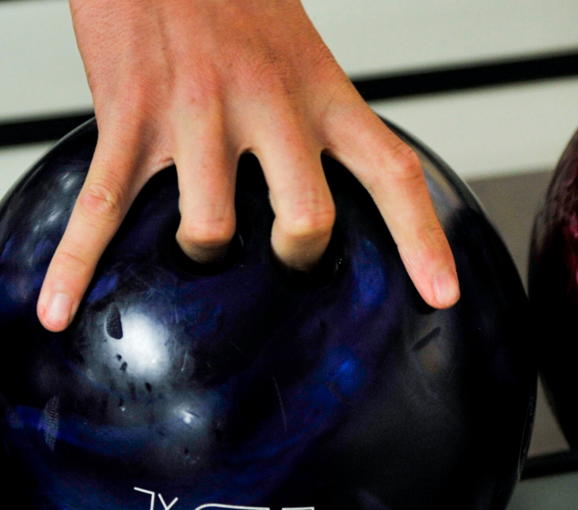 Airman 1st Class Javier Nunez-Chavez, a 19th Logistics Readiness Squadron vehicle maintainer, picks up a bowling ball as he prepares to pick up a spare July 8, 2015, at Little Rock Air Force Base, Ark. Strike Zone Bowling Center lanes are open Monday-Wednesday from 6-9 p.m. Thursday from 5-10 p.m. Friday from 5-12 p.m. and Saturday from noon to 11 p.m. (U.S. Air Force photo by Senior Airman Stephanie Serrano)
