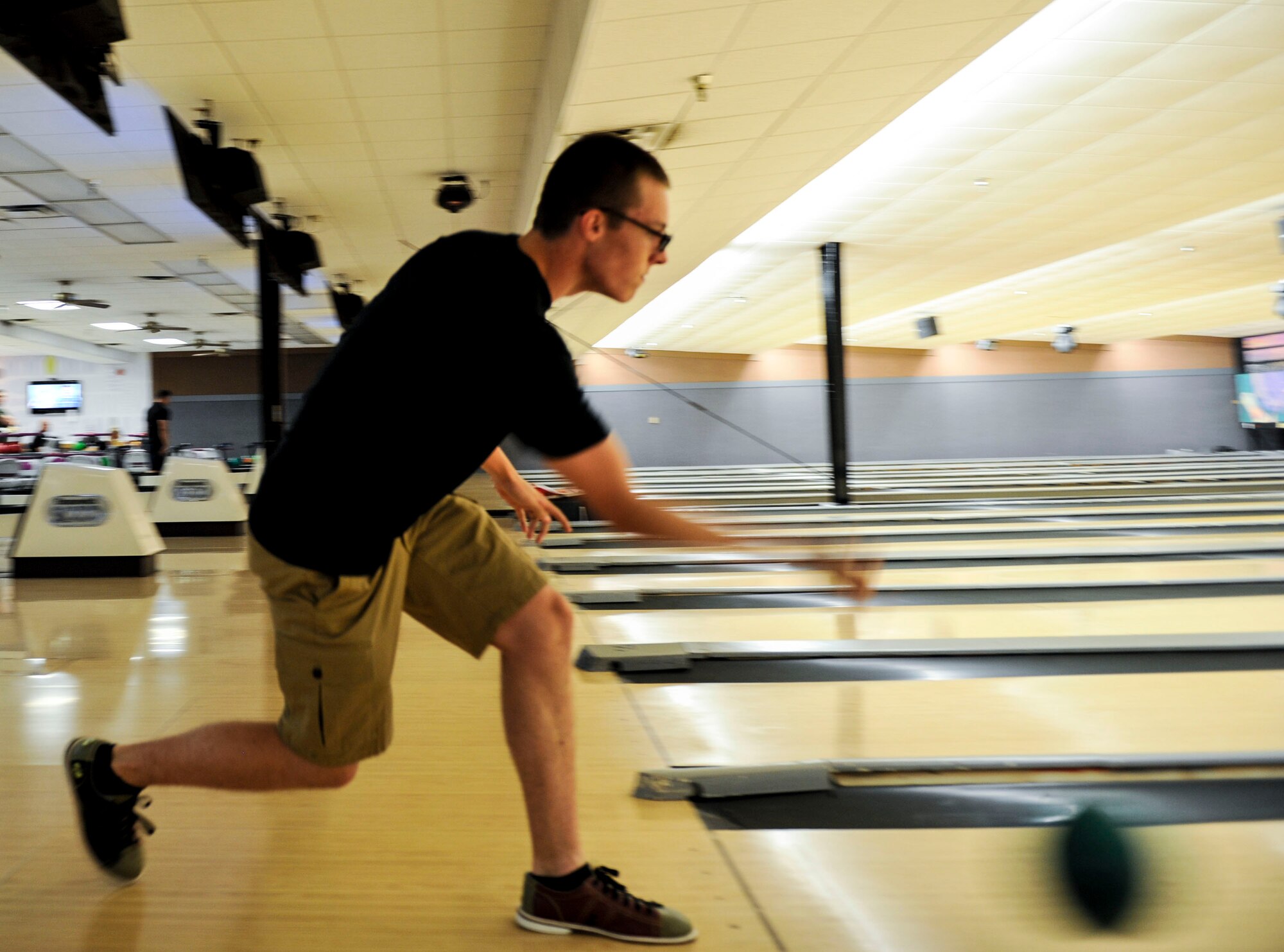 Airman 1st Class Nicholas Chisler, a 19th Maintenance Squadron fuels systems operator, bowls for a spare July 8, 2015, at Little Rock Air Force Base, Ark. Strike Zone Bowling Center invites single active duty members to bowl for free on Monday nights from 6-9 p.m. (U.S. Air Force photo by Senior Airman Stephanie Serrano)
