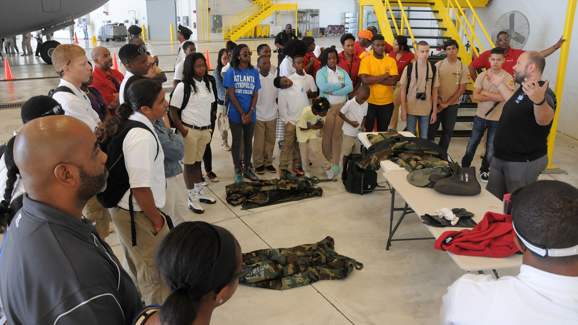 WRIGHT-PATTERSON AIR FORCE BASE, Ohio – Tech. Sgt. Steve Bertonaschi, 445th Civil Engineer Squadron emergency management craftsman, talks to Dream Flight participants about the various chemical warfare gear worn by Airmen and its purpose. More than 180 students ages 14-18 and their chaperons visited the 445th Airlift Wing July 22, 2015 as part of the 16th Annual Delta Airlines sponsored Dream Flight program. (U.S. Air Force photo/Tech. Sgt. Anthony Springer)