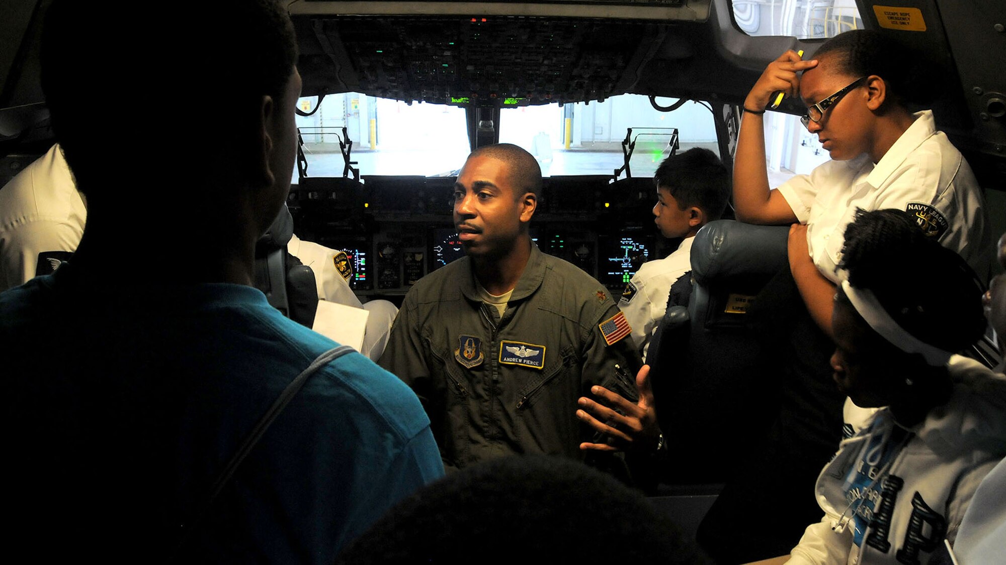 WRIGHT-PATTERSON AIR FORCE BASE, Ohio – Maj. Andrew Pierce, 89th Airlift Squadron C-17 pilot, shows Dream Flight participants the flightdeck area of a C-17 Globemaster III during the group’s visit to the 445th Airlift Wing July 22, 2015. More than 180 students ages 14-18 and their chaperons visited the wing as part of the 16th Annual Delta Airlines sponsored Dream Flight program. (U.S. Air Force photo/Tech. Sgt. Anthony Springer)