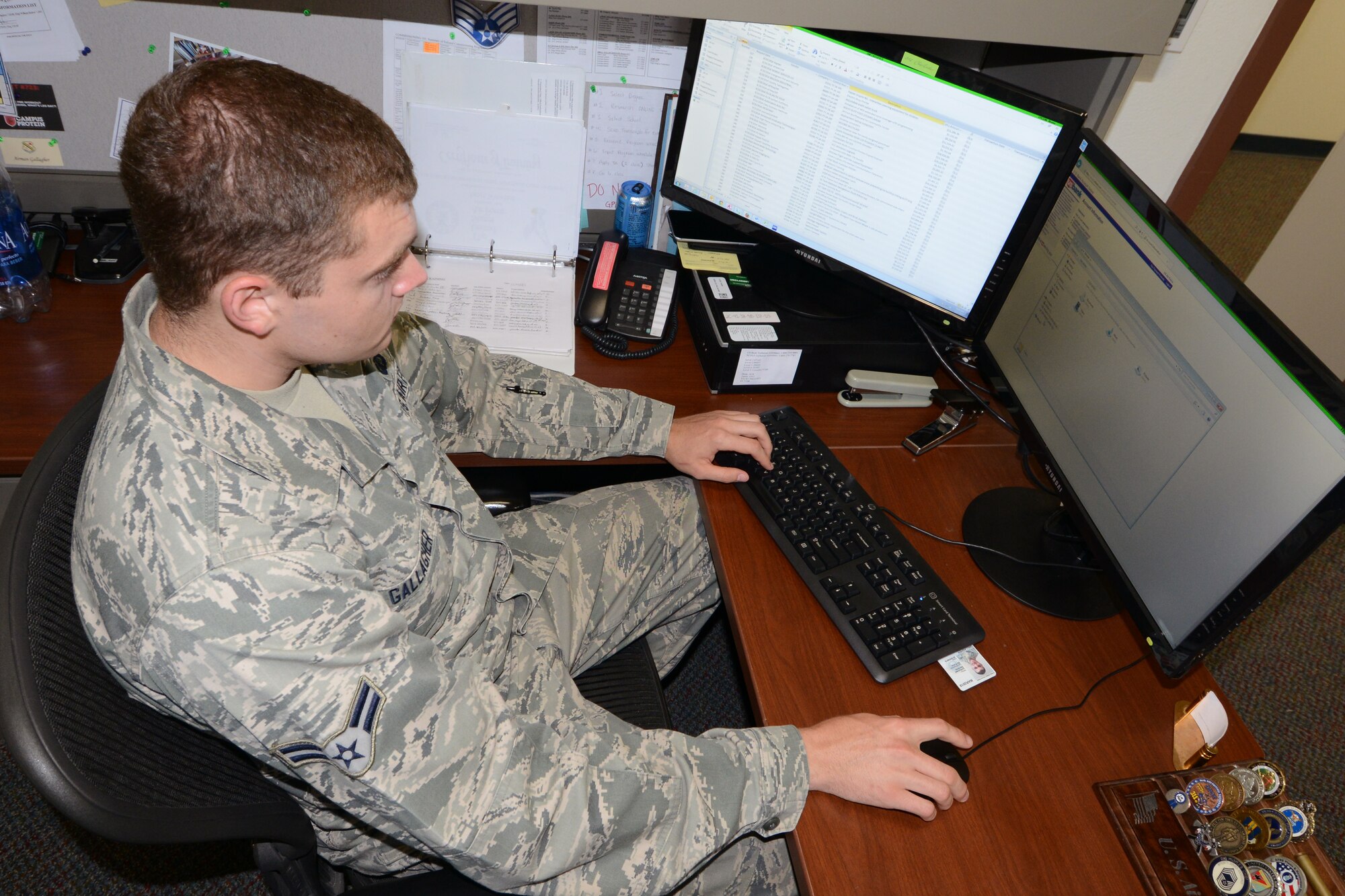 U.S. Air Force Airman 1st Class Christopher Gallagher, a 354th Contracting Squadron coordinator for the Government Purchasing Card program, processes single purchase limit increases July 21, 2015, at Eielson Air Force Base, Alaska. Gallagher is in charge of purchases up to $25,000 and oversees cardholders throughout multiple bases in the Pacific Air Forces region. (U.S. Air Force photo by Senior Airman Ashley Nicole Taylor/Released)
