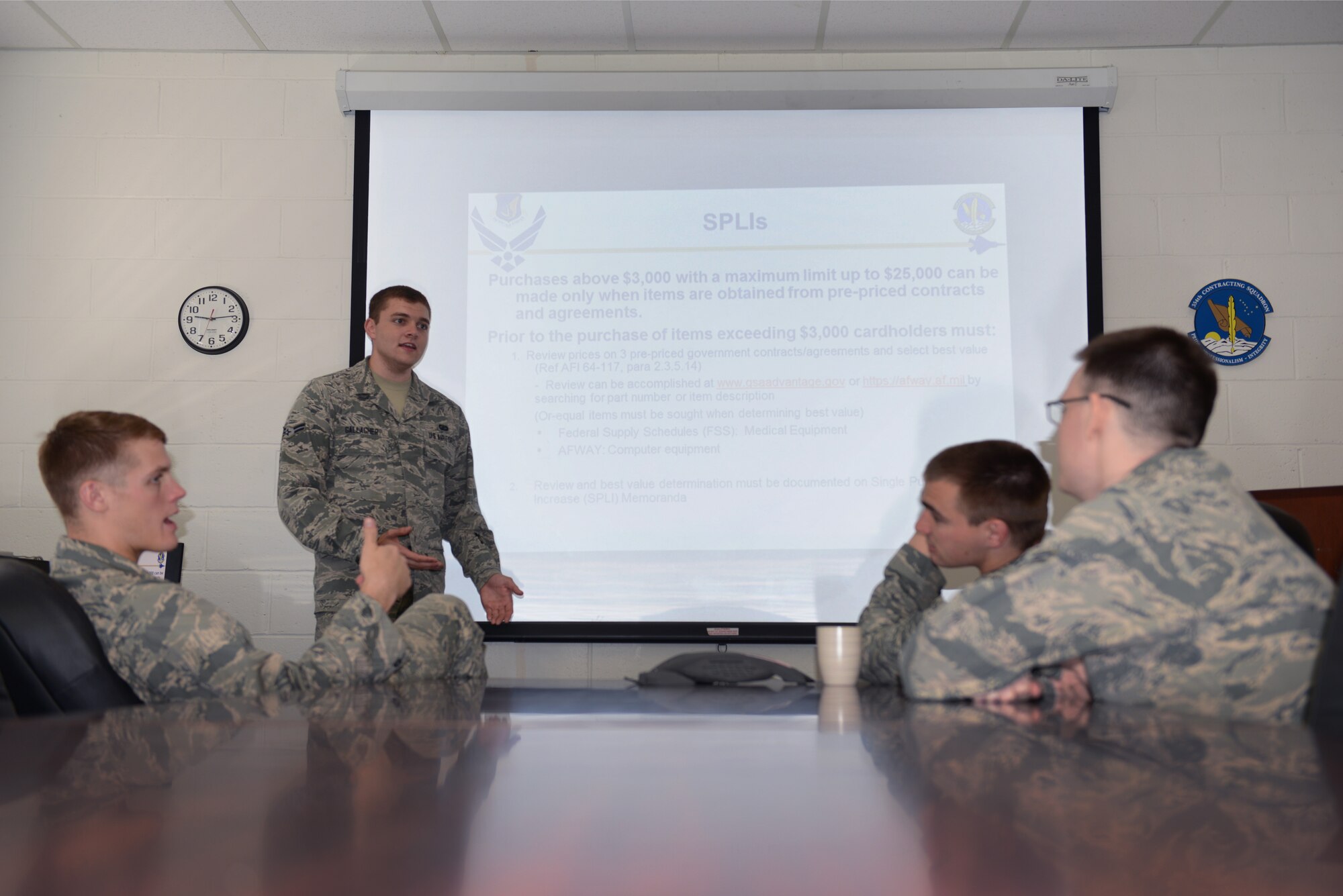 U.S. Air Force Airman 1st Class Christopher Gallagher, a 354th Contracting Squadron coordinator for the Government Purchasing Card program, trains other squadron members on single purchase limit increases July 21, 2015, at Eielson Air Force Base, Alaska. Gallagher conducts training monthly or on an as-needed basis. (U.S. Air Force photo by Senior Airman Ashley Nicole Taylor/Released)