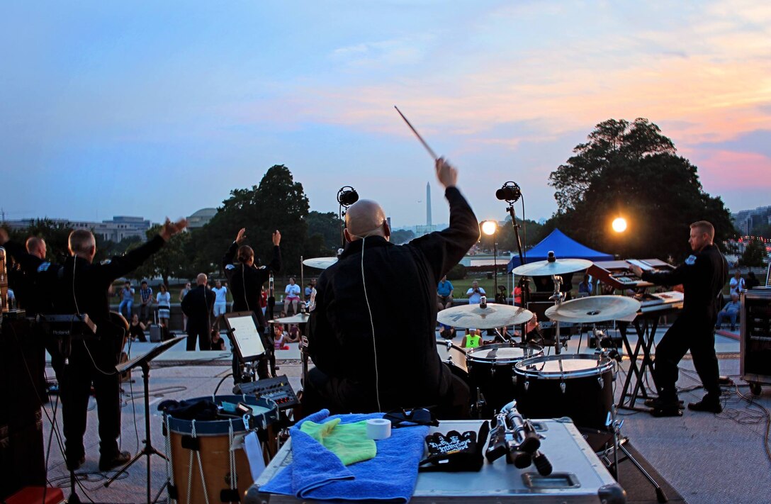 Technical Sgt. Robert Smith plays drumset with Max Impact during an evening concert on the Capitol Steps in downtown Washington D.C. (U.S. Air Force photo by Master Sgt. Adam Dempsey/released) 

