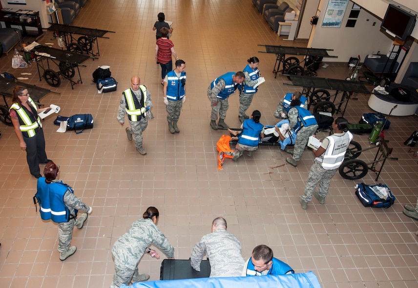 Members of the 5th Medical Group treat simulated trauma victims during an exercise at Minot Air Force Base, N.D., July 22, 2015. The exercise tested the skills of emergency response personnel and a variety of base agencies: firefighters, emergency medical technicians and 54th Helicopter Squadron crew members. (U.S. Air Force photo/Senior Airman Stephanie Morris)