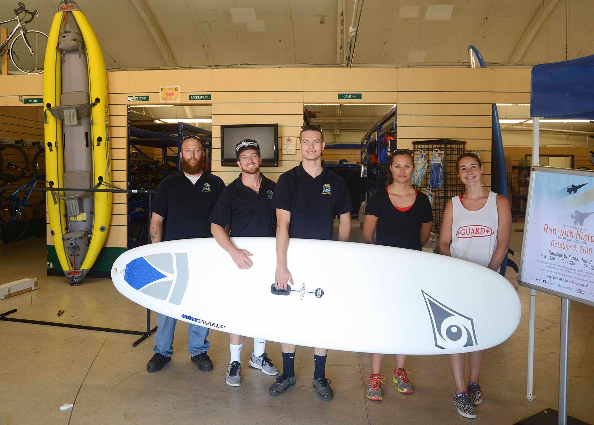 Members of the Edwards AFB Outdoor Recreation staff pose with one of ODR's new paddle boards. ODR offers anything from surfboards and wet suits to mountain bikes and kayaks for your summer needs. (U.S. Air Force photo by Patric Lovato)