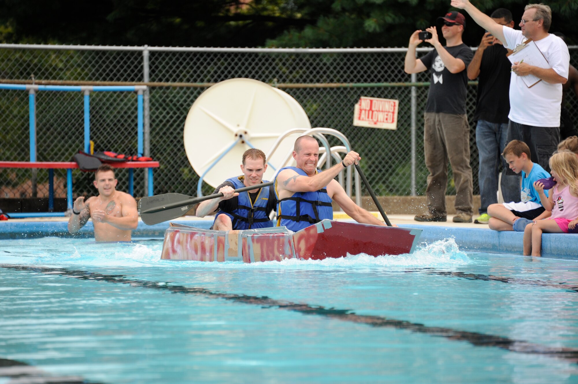 The Fourth Annual Cardboard Boat Regatta was held at the Dix Outdoor Pool on Joint Base McGuire-Dix-Lakehurst, N.J. July 18, 2015. Nine crews consisting of service members and civilians, utilizing sheets of cardboard and duct tape, constructed boats from the initial planning stages to the actual floating of the boats in a contest to determine the fastest time, unique theme, team spirit and dramatic sinking. (U.S. Air Force photo by Pascual Flores)