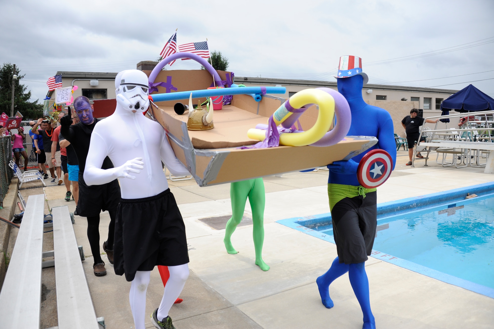 The Fourth Annual Cardboard Boat Regatta was held at the Dix Outdoor Pool on Joint Base McGuire-Dix-Lakehurst, N.J. July 18, 2015. Nine crews consisting of service members and civilians, utilizing sheets of cardboard and duct tape, constructed boats from the initial planning stages to the actual floating of the boats in a contest to determine the fastest time, unique theme, team spirit and dramatic sinking. (U.S. Air Force photo by Pascual Flores)