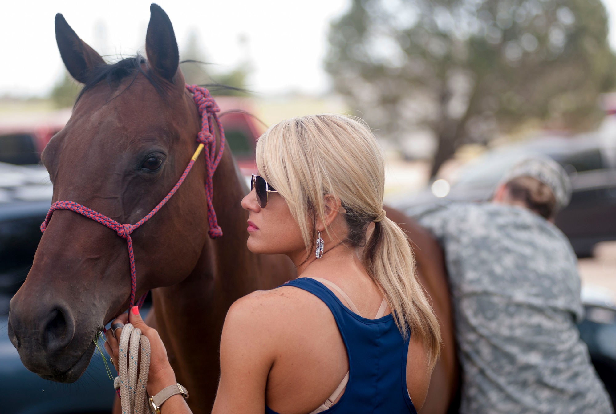 Chrissy Belcher holds her horse, Geannie, while Army Capt. Shannon McLean checks Geannie's temperature July 17, 2015, at Fort D.A. Russell Days. All horses participating in Horses for Heroes went through a wellness check and had to show their vaccination records. (U.S. Air Force photo by Katherine Oriez)
