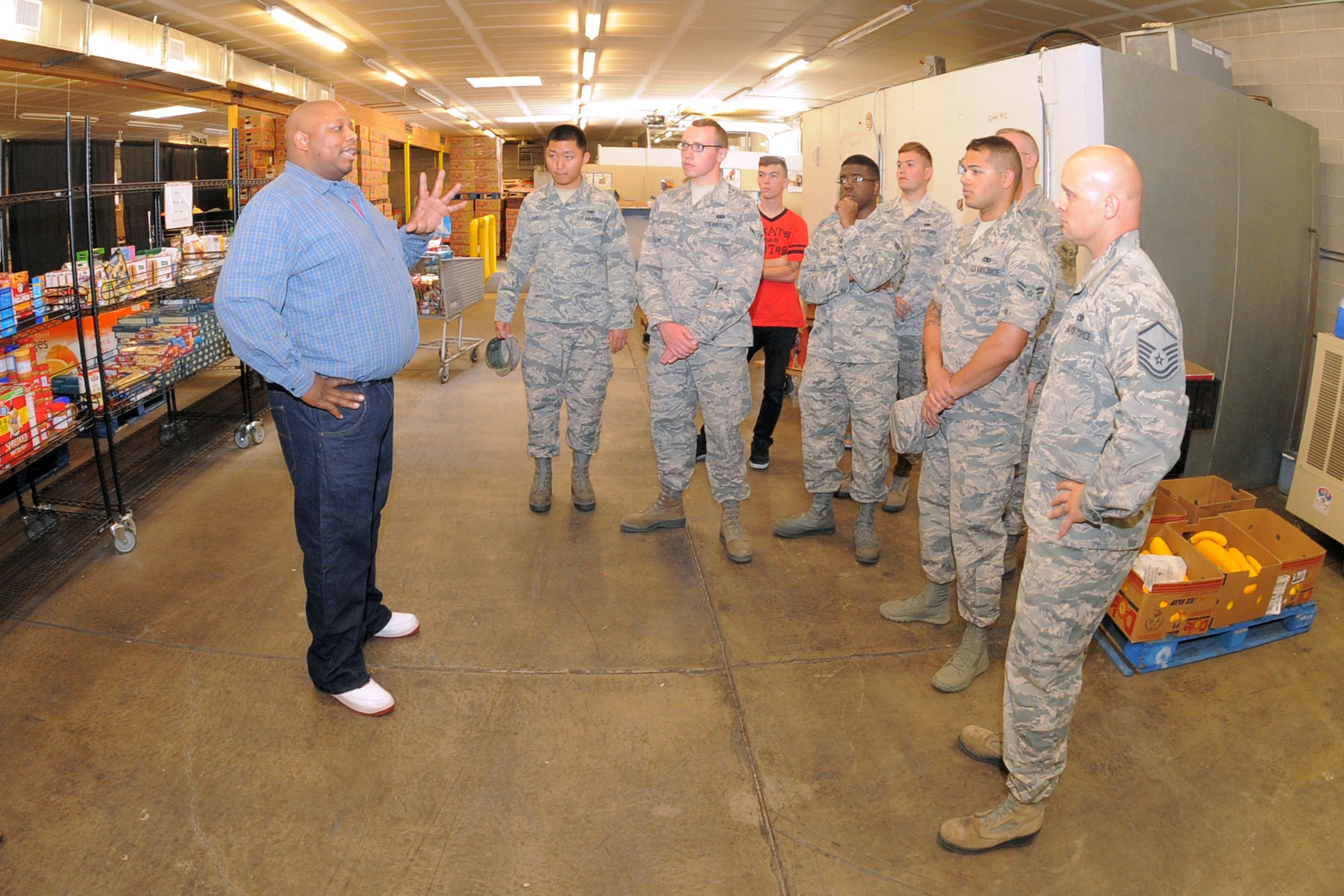 Lamont Hampton explains the Family Connection Center’s food distribution operation to Hill Air Force Base airmen July 21 at the center in Layton, Utah. Airmen were at the center to deliver donated food items as part of the annual Department of Defense ‘Feds Feed Families Food Drive.’ (U.S. Air Force Photo by Todd Cromar/Released)