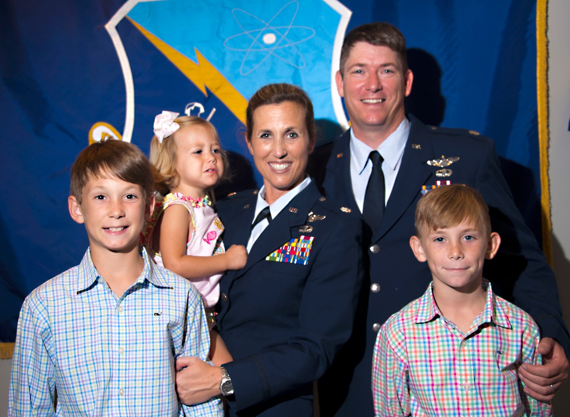 Lt. Col. Loralie Rasmussen, Officer Training School Detachment 12 commander, and her husband, Lt. Col. Reid Rasmussen, Air War College student, take a moment with their family after the change of command ceremony July 16, 2015, Maxwell Air Force Base, Alabama. The couple has three children, from left to right, Foster, Amelia Grace and Emmett. (U.S. Air Force photo by Airman 1st Class Alexa Culbert/Cleared)
