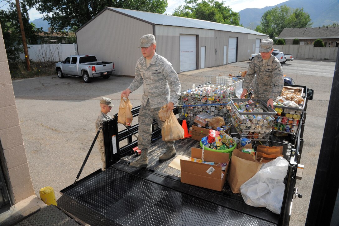 Airman 1st Class Dillion Cutlip, left, 388th Component Maintenance Squadron, and Airman Matthew Nugent, 729th Air Control Squadron, deliver food donated by Hill Air Force Base Commissary patrons to the Family Connection Center in Layton, Utah July 21. This year’s drive runs through October and the Commissary is a collection point for donations. Donation boxes are also located in many base organizations. (U.S. Air Force Photo by Todd Cromar/Released)