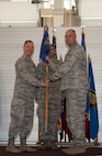 Col. Andrew Kovich, former 91st Maintenance Group Commander, hands off the guidon at the 91st MXG change of command ceremony at Minot Air Force Base, N.D., July 20, 2015. Kovich gave over the command to Col. Earl Bennett, 91st MXG Commander, at the ceremony. Bennett’s previous assignment was the Air Force Inspection Agency deputy chief at Kirkland AFB, N.M. (U.S. Air Force photo/Airman 1st Class Christian Sullivan)
