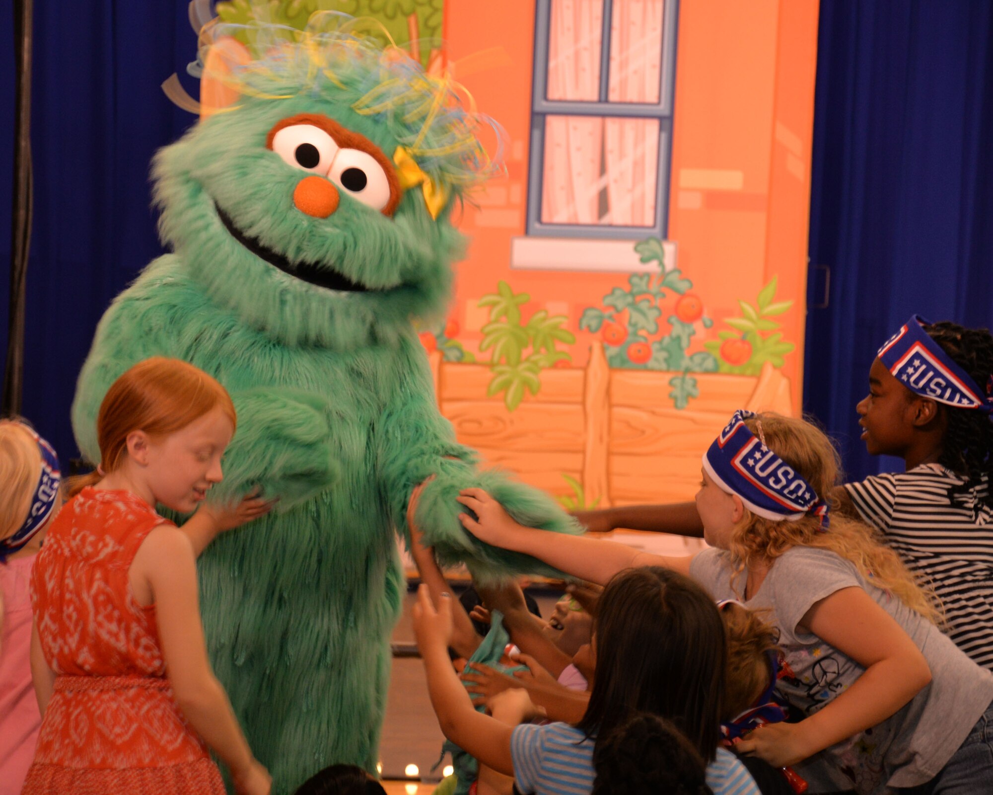 Sesame Street characters interact with Team Mildenhall children during a United Service Organizations event July, 22, 2015, at the youth center on RAF Mildenhall, England. The USO administers family programs and provides entertainment for deployed service members and family members, as well as provides support for wounded warriors. (U.S. Air Force photo by Gina Randall/Released)