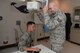Tech. Sgt. Matthew Fischer, 22nd Medical Support Squadron diagnostic imaging technologist, examines Airman 1st Class Daniel Mayle, 22nd Maintenance Squadron crew chief, with an X-ray machine at McConnell Air Force Base, Kan., July 20, 2015.  Members of the radiology department ensure Team McConnell stays healthy by producing the highest quality images for X-ray, ultrasound, mammography and bone density examinations to assist health care providers in their diagnostic treatment.  (U.S. Air Force photo by Senior Airman Colby Hardin)