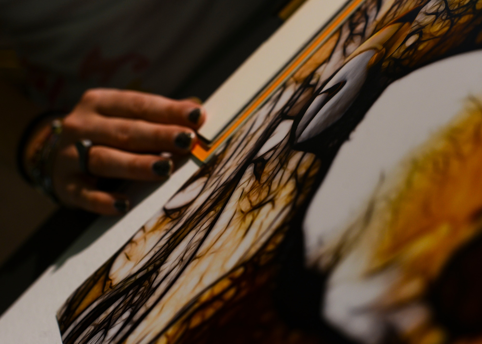 Nancy Bruno, 31st Force Support Squadron custom frame designer, customizes a frame for a piece of art, July 23, 2015, at Aviano Air Base, Italy. To help crafters, the store offers painting, sewing and other classes. (U.S. Air Force photo by Senior Airman Austin Harvill/Released)
