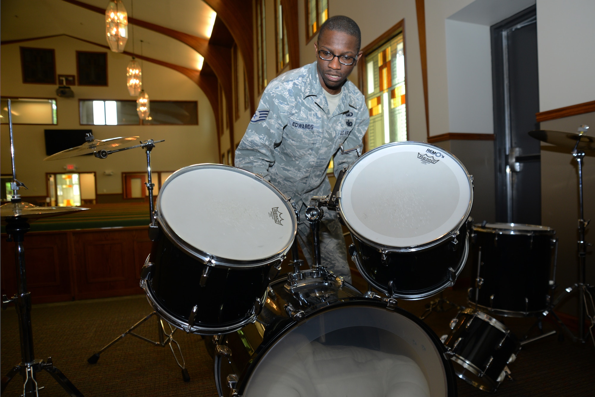 Staff Sgt. Byron Edwards, 22nd Air Refueling Wing Chapel program support NCO in charge, arranges a drum set while moving to the base chapel after renovations, July 22, 2015, at McConnell Air Force Base, Kan. The renovations brought the chapel into the modern age with a slew of technological and standard-of-living improvements made in both the workshop and worship areas. (U.S. Air Force photo by Airman 1st Class Christopher Thornbury)