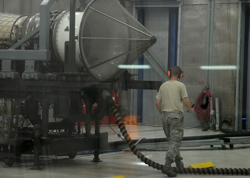U.S. Air Force Senior Airman Michael Smith, 1st Maintenance Squadron aerospace propulsion technician, checks an F-22 Raptor engine for leaks during an engine run at Langley Air Force Base, Va., July 22, 2015. Smith inspects the engine after each test to ensure no further repairs are required. (U.S Air Force photo by Airman 1st Class Derek Seifert/Released)