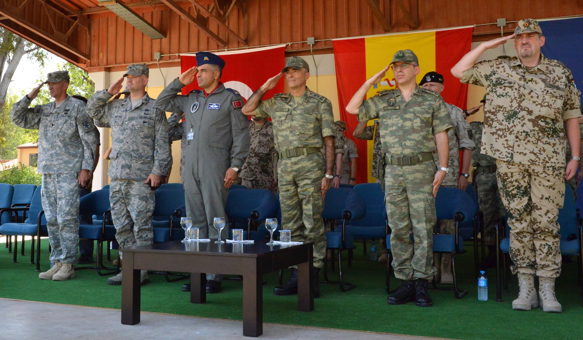 Senior leaders from the U.S. Air Force and Army, as well as the Turkish air force and Spanish army salute the flag during the playing of the Turkish and Spanish national anthems during a Transfer of Authority ceremony, July 22, 2015, at Incirlik Air Base, Turkey. The Spanish unit will serve three more rotations in the city of Adana in support of Operation Active Fence. (U.S. Air Force photo by Senior Airman Michael Battles/Released)