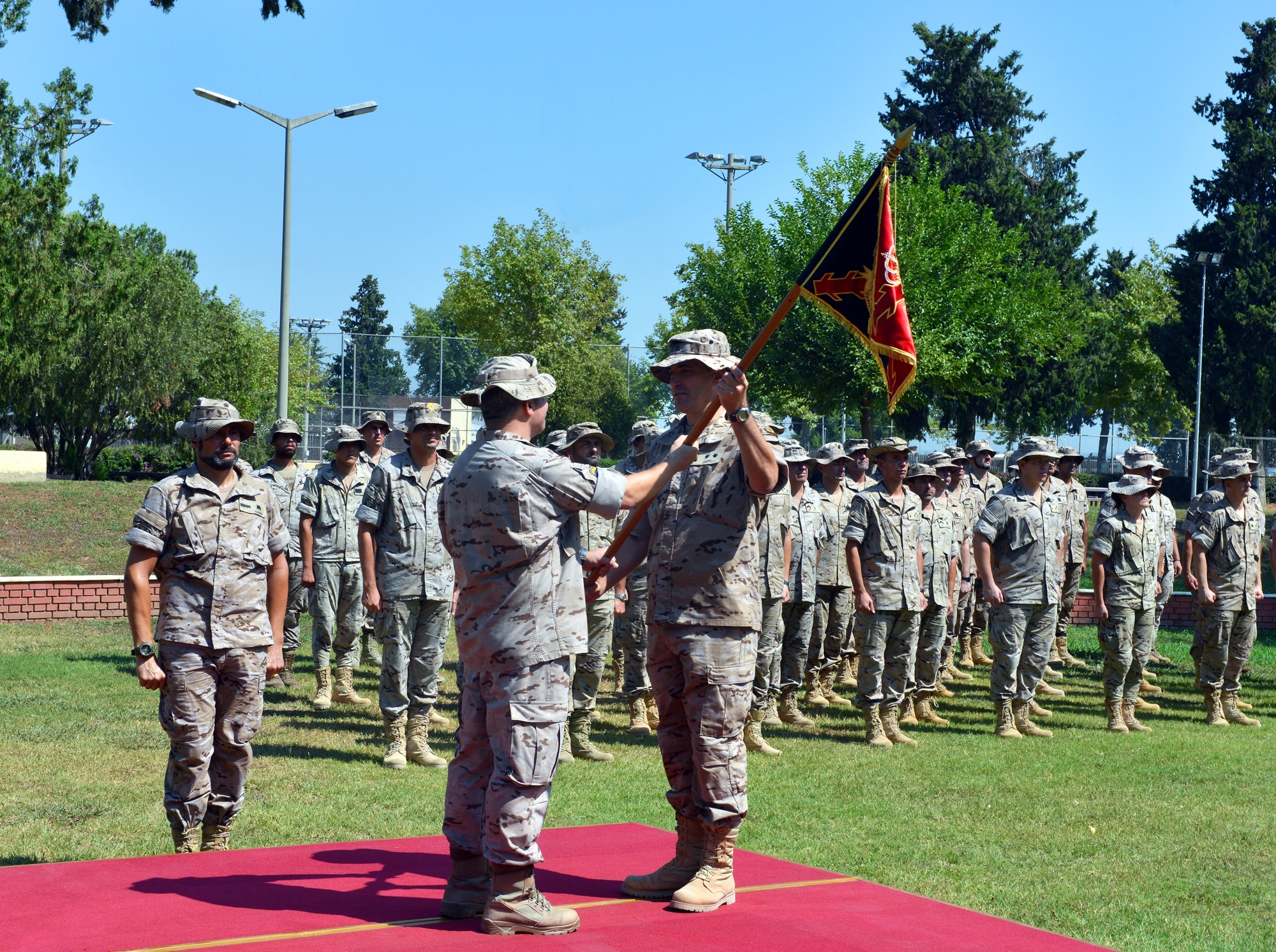 Spanish CDR. Jorge Cotorruelo, outgoing Spanish Patriot Unit commander, passes on the unit guidon to Army Artillery LTC Juan Castilla, incoming SPU commander, during a Transfer of Authority ceremony July 22, 2015, at Incirlik Air Base, Turkey. The Spanish unit has been deployed to Incirlik since January in support of Operation Active Fence. (U.S. Air Force photo by Senior Airman Michael Battles/Released)