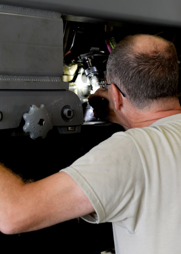 Virginia Air National Guard Master Sgt. Russell Tilley, 192nd Maintenance Squadron aerospace propulsion technician, checks wires for possible damage during a pre-test inspection on an F-22 Raptor engine at Langley Air Force Base, Va., July 22, 2015. Propulsion technicians conduct tests to ensure the engine is working properly. (U.S. Air Force photo by Airman 1st Class Derek Seifert/Released)