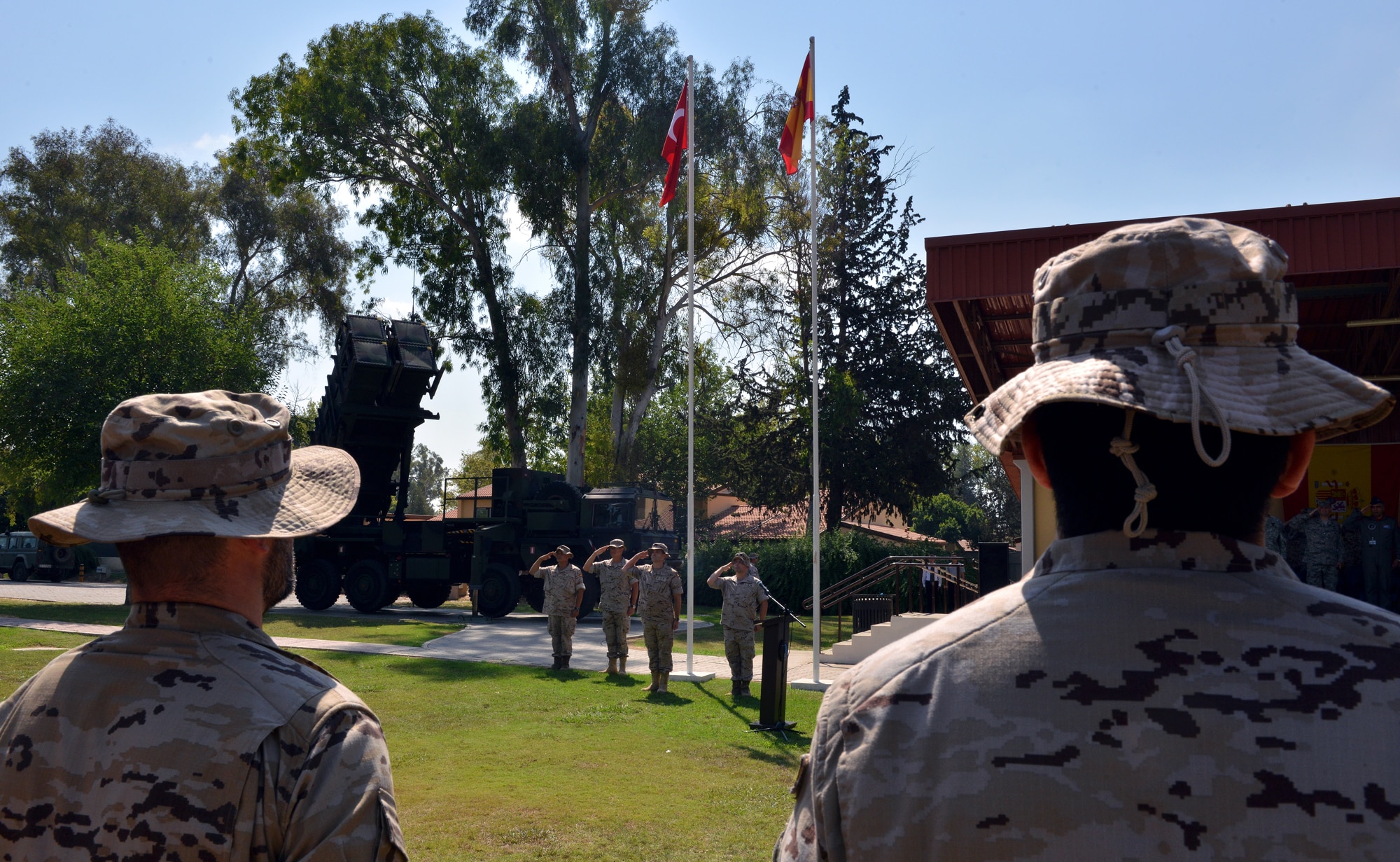 Leaders from the Spanish military salute the flag during the playing of the Turkish and Spanish national anthems during a Transfer of Authority ceremony July 22, 2015, at Incirlik Air Base, Turkey. NATO allies from Spain, Turkey, Germany and the U.S. were in attendance at the ceremony. (U.S. Air Force photo by Senior Airman Michael Battles/Released))