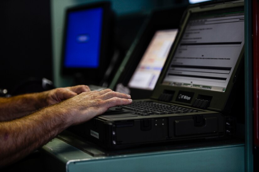 A U.S. Air Force Airman prepares for an engine run at Langley Air Force Base, Va., July 22, 2015. Within the testing cab, Airmen use computer systems linked to the engines to perform automatic or manual tests. (U.S. Air Force photo by Senior Airman Kayla Newman/Released)