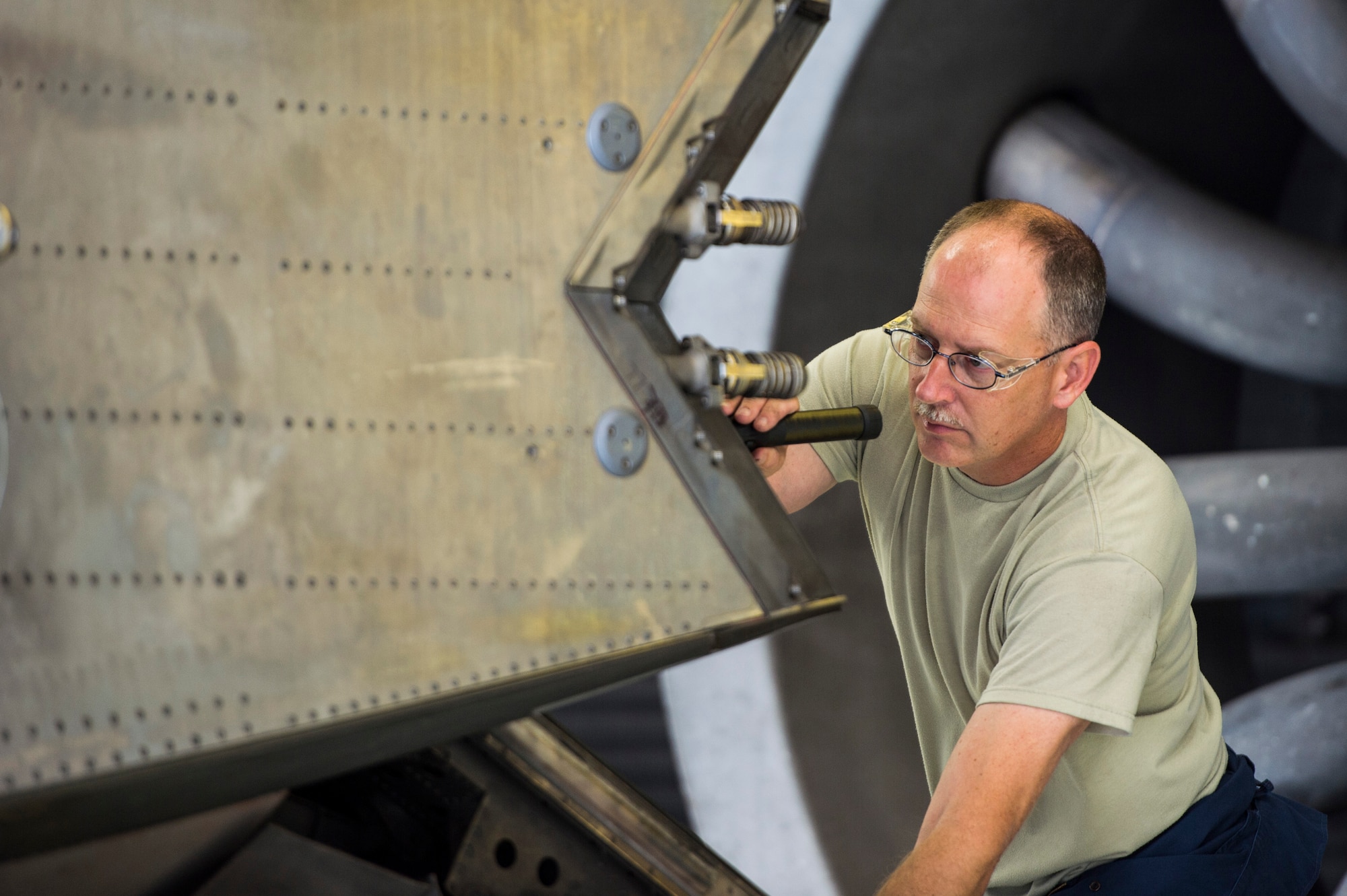 Virginia Air National Guard Master Sgt. Russell Tilley, 192nd Maintenance Squadron aerospace propulsion technician, conducts a pre-test inspection on a Pratt and Whitney F119 engine at Langley Air Force Base, Va., July 22, 2015. The engine powers the F-22 Raptor and produces more thrust than any other current fighter jet engine. (U.S. Air Force photo by Senior Airman Kayla Newman/Released)