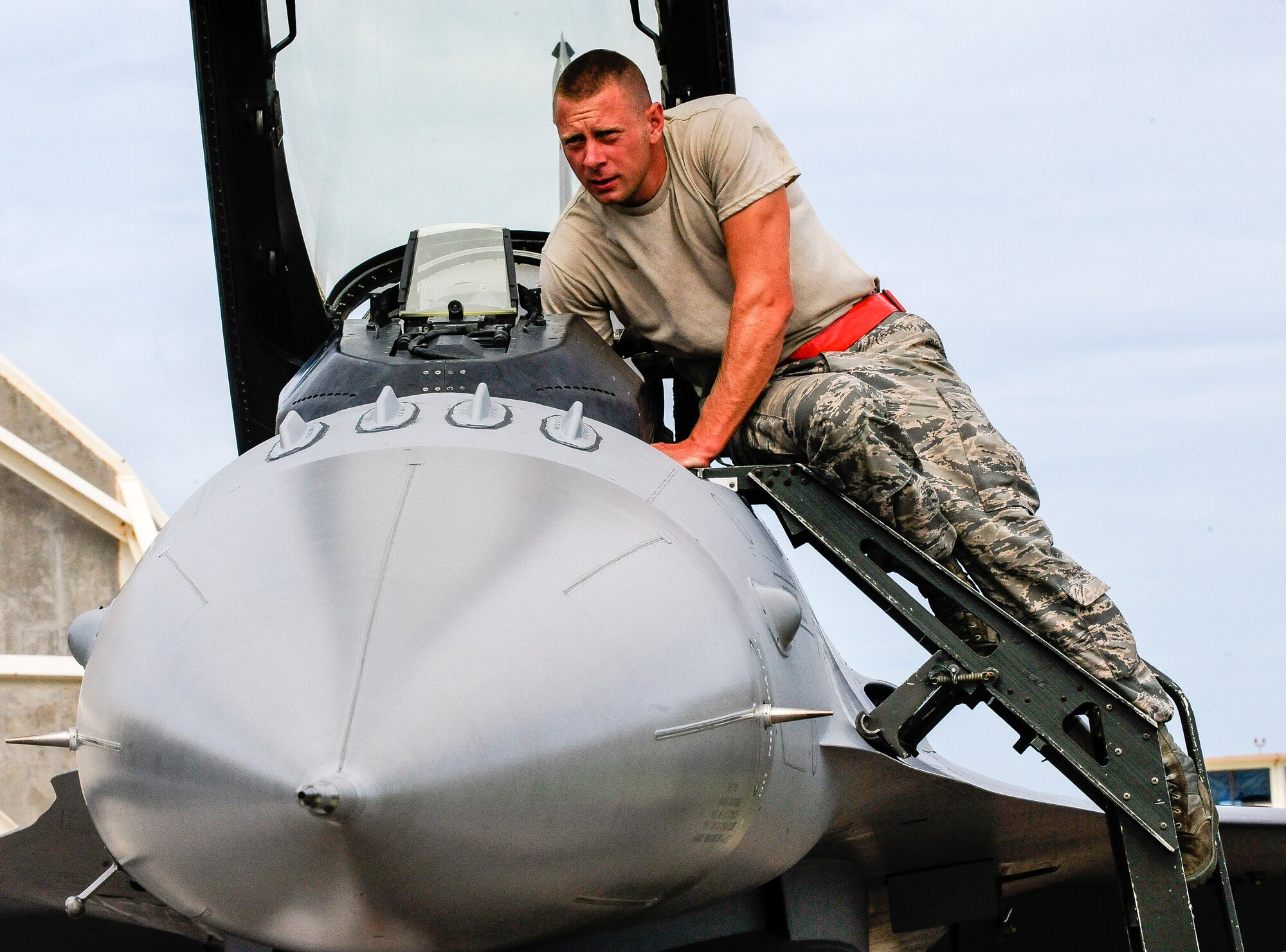 U.S. Air Force Master Sgt. David Custer, Vermont Air National Guard’s 158th Maintenance Squadron lead crew chief, services the cockpit of a U.S. Air Force F-16 Fighting Falcon July, 22, 2015, on Kadena Air Base, Japan. Custer has been an ANG Airman for 12 years and has spent 11 of them within the same unit along with some of his peers. The F-16 provides a relatively low-cost, high-performance weapon system for the U.S. and allied nations. (U.S. Air Force photo by Airman 1st Class John Linzmeier) 