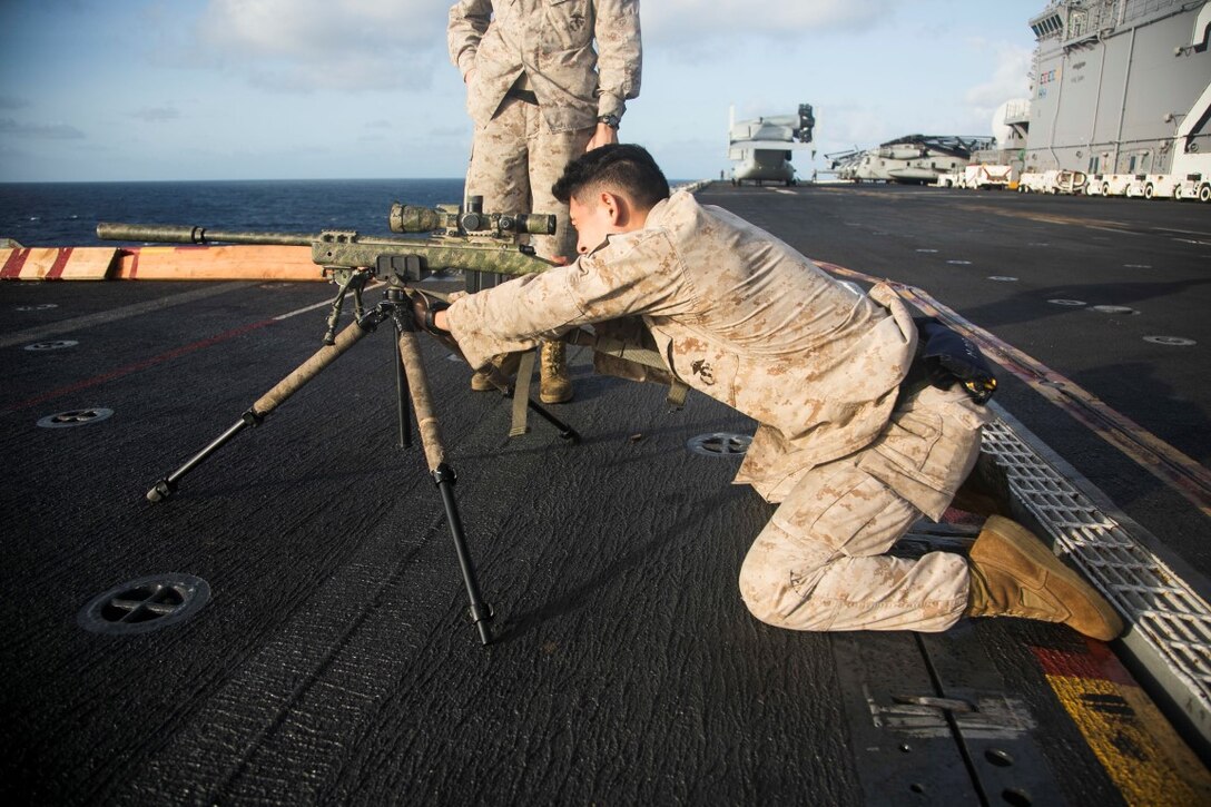 U.S. Marine Cpl. Roberto Sauceda prepares to shoot a sniper rifle aboard the amphibious assault ship USS Essex (LHD 2). Sauceda is a point man with the scout sniper platoon, Weapons Company, Battalion Landing Team 3rd Battalion, 1st Marine Regiment, 15th Marine Expeditionary Unit MEU. Elements of the 15th MEU, based out of Camp Pendleton, Calif., and embarked aboard the Essex, are conducting naval operations in the 6th Fleet areas of operation in support of U.S. national security interests in Europe and Africa. (U.S. Marine Corps photo by Cpl. Anna Albrecht/Released)