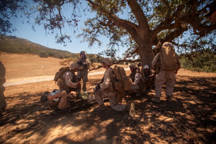 Infantry Marines with 3rd Platoon, Company C, 1st Battalion, 7th Marines, provide security for a simulated victim at landing zone K Springs aboard Marine Corps Base Camp Pendleton, Calif., July 17, while awaiting pick up from a tactical recovery of aircraft and personnel mission during a certification exercise for Special Purpose Marine Air-Ground Task Force Crisis Response Central Command 16.1. SPMAGTF-CR-CC is a fully capable crisis response unit with the ability to project power over the vast distances using organic air and ground combat assets.