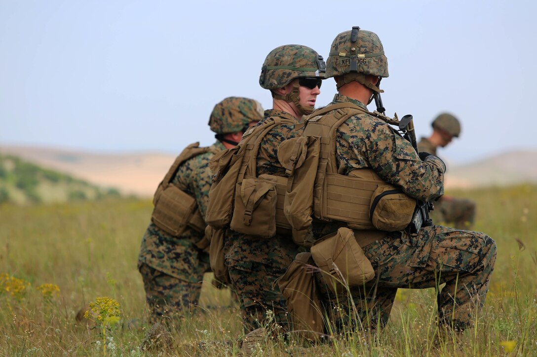 U.S. Marine 1st Lt. Seth Kellogg (right), platoon commander for the live-fire range, speaks with  1st Lt. Caleb Clubb (left), Officer-in-Charge of the range, before starting the live-fire platoon attack at Babadag Training Area, Romania, July 2. Clubb and Kellogg are platoon commanders with Golf Company, Black Sea Rotational Force. 1st Lt. Kellogg’s platoon continuously supported monthly week-long military-to-military engagements with the Romanian 307th Naval Infantry during BSRF 15.1’s six-month deployment. The engagements culminated with the U.S. and Romanian platoon live-fire attacks. (U.S. Marine Corps photo by 1st Lt. Sarah E. Burns)