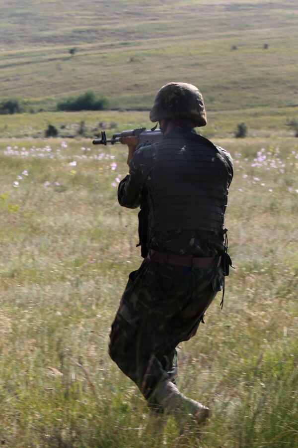 A Romanian marine with the 307th Naval Infantry Battalion lays down suppressive fire during the Romanian platoon-attack at Babadag Training Area, July 2. U.S. and Romanian troops conducted live-fire platoon attacks at BTA as the culmination of monthly military-to-military engagements between BSRF and the Romanian 307th Naval Infantry. (U.S. Marine Corps photo by 1st Lt. Sarah E. Burns)