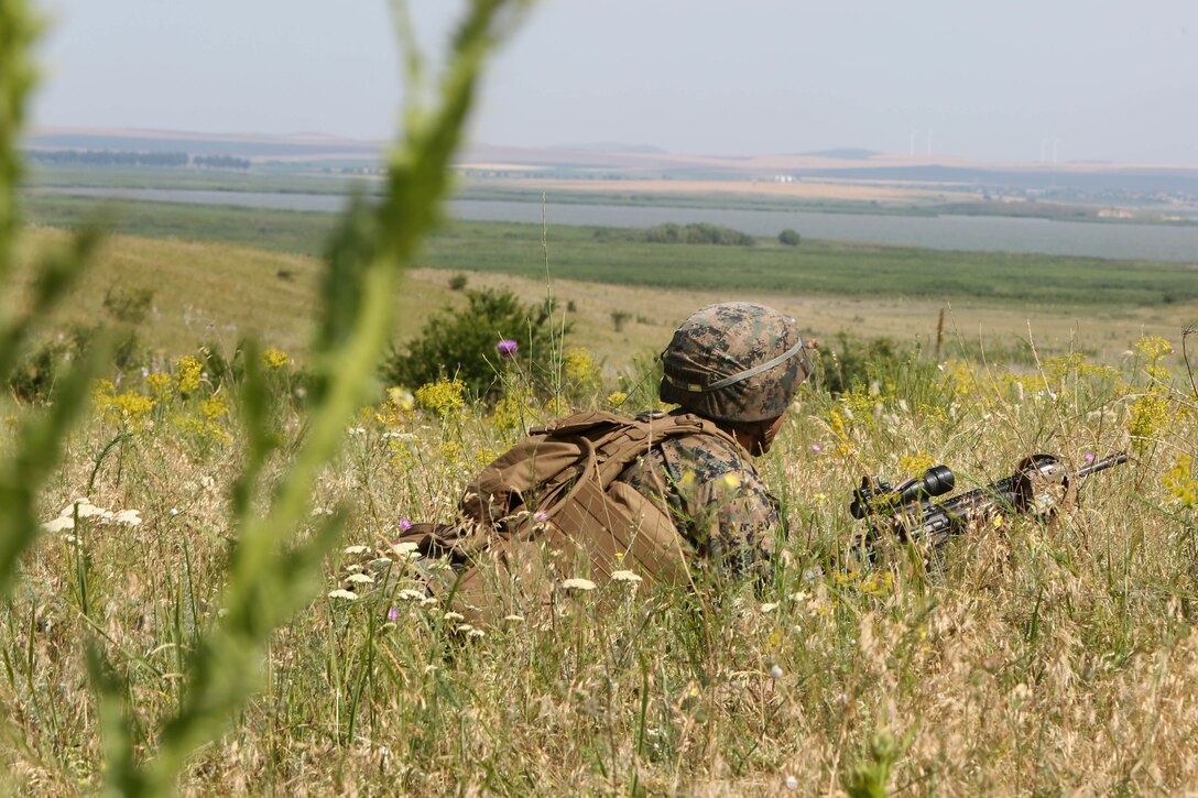 A U.S. Marine with Golf Company, Black Sea Rotational Force, gets in the prone position to fire his M16A4 service rifle during the Marines’ platoon-attack at Babadag Training Area, July 2. U.S. and Romanian troops conducted live-fire platoon attacks at BTA as the culmination of monthly military-to-military engagements between BSRF and the Romanian 307th Naval Infantry. (U.S. Marine Corps photo by 1st Lt. Sarah E. Burns)