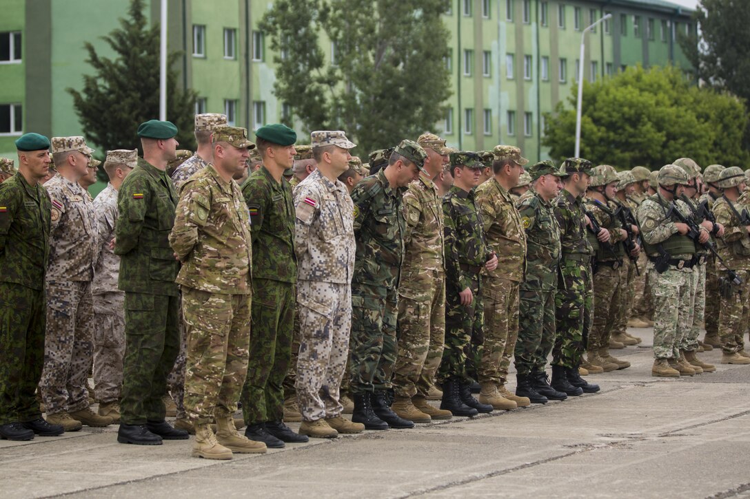 Forces stand in formation for the opening ceremony of Agile Spirit 15, a multilateral exercise at Vaziani Training Area, Georgia, July 8, 2015. This fifth iteration of the Agile Spirit exercise was established to exercise interoperability with capacity to conduct planning and execution in support of the North Atlantic Treaty Organization Response Force operations with U.S., Georgian Armed, Bulgaria, Romania, Latvia, and Lithuania forces. (U.S. Marine Corps photo by Cpl. Rebecca L. Floto, 2nd Marine Division, Combat Camera/ Released)