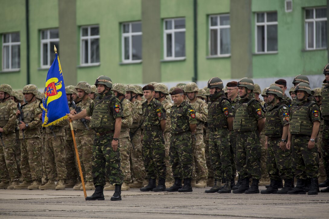 Forces stand in formation for the opening ceremony of Agile Spirit 15, a multilateral exercise at Vaziani Training Area, Georgia, July 8, 2015. This fifth iteration of the Agile Spirit exercise was established to exercise interoperability with capacity to conduct planning and execution in support of the North Atlantic Treaty Organization Response Force operations with U.S., Georgian Armed, Bulgaria, Romania, Latvia, and Lithuania forces. (U.S. Marine Corps photo by Cpl. Rebecca L. Floto, 2nd Marine Division, Combat Camera/ Released)
