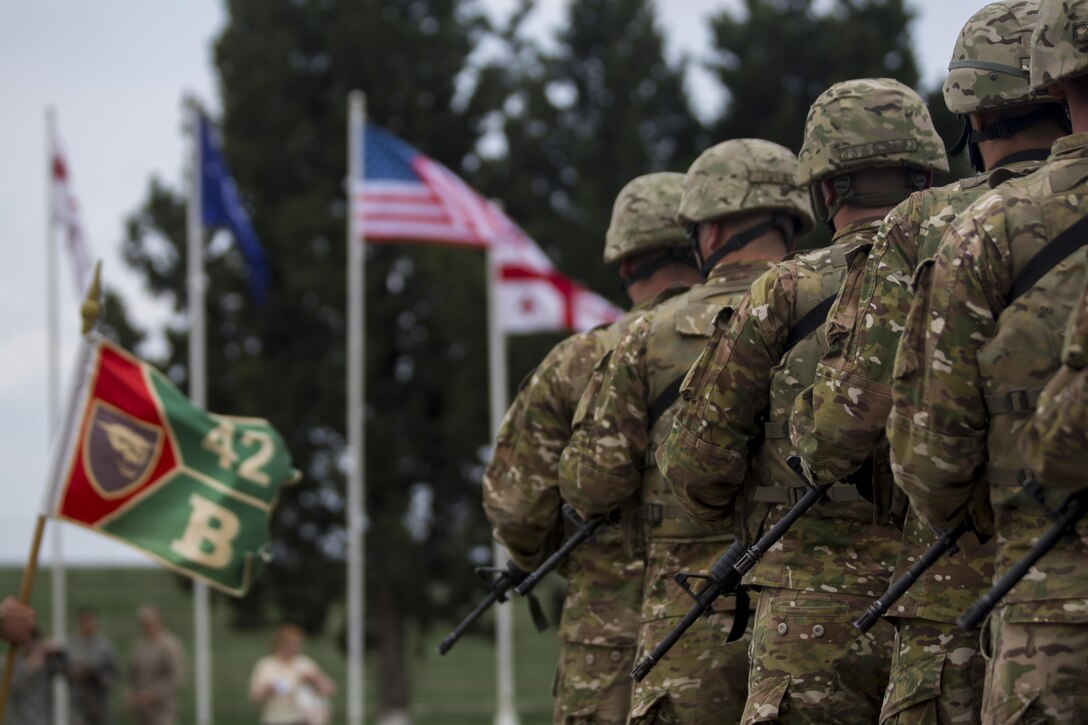Forces stand in formation for the opening ceremony of Agile Spirit 15, a multilateral exercise at Vaziani Training Area, Georgia, July 8, 2015. This fifth iteration of the Agile Spirit exercise was established to exercise interoperability with capacity to conduct planning and execution in support of the North Atlantic Treaty Organization Response Force operations with U.S., Georgian Armed, Bulgaria, Romania, Latvia, and Lithuania forces. (U.S. Marine Corps photo by Cpl. Rebecca L. Floto, 2nd Marine Division, Combat Camera/ Released)