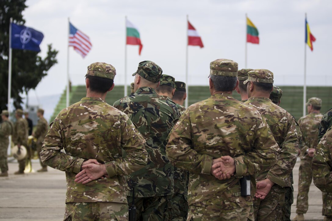 Forces stand in formation for the opening ceremony of Agile Spirit 15, a multilateral exercise at Vaziani Training Area, Georgia, July 8, 2015. This fifth iteration of the Agile Spirit exercise was established to exercise interoperability with capacity to conduct planning and execution in support of the North Atlantic Treaty Organization Response Force operations with U.S., Georgian Armed, Bulgaria, Romania, Latvia, and Lithuania forces. (U.S. Marine Corps photo by Cpl. Rebecca L. Floto, 2nd Marine Division, Combat Camera/ Released)
