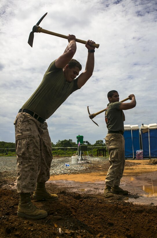 U.S. Marine Sgt. Floyd Rude, a member of Special-Purpose Marine Air-Ground Task Force Crisis Response-Africa, digs a drainage ditch after a rainstorm in Accra, Ghana, April 1, 2015. The Marines created similar ditches around their Cooperative Security Location to protect against flooding inside the small compound. (U.S. Marine Corps photo by Sgt. Paul Peterson/Released)